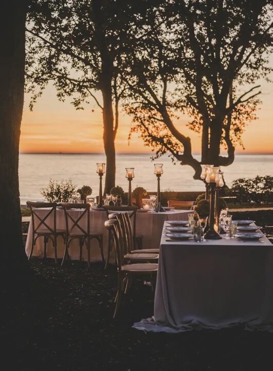 Outdoor wedding dinner in the D'Orangerie garden at sunset